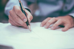 man-writing-on-paper.jpg man writing on paper